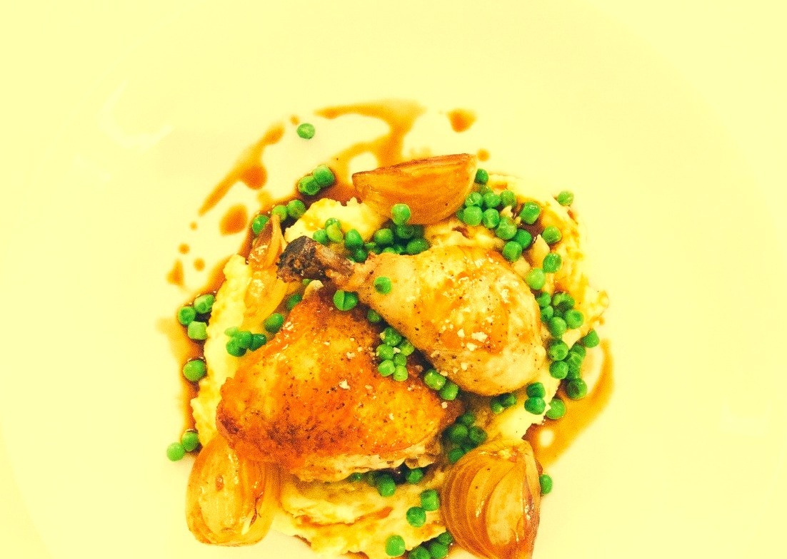 SEARED CHICKEN WITH BRAISED ONIONS PEAS AND MASH.
